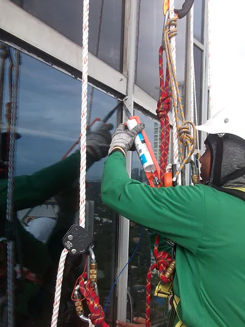 A sealant gun applying a new bead along a window frame