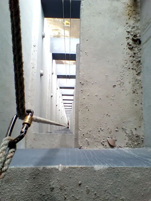 A rope rigged over a wall edge for an inspection drop